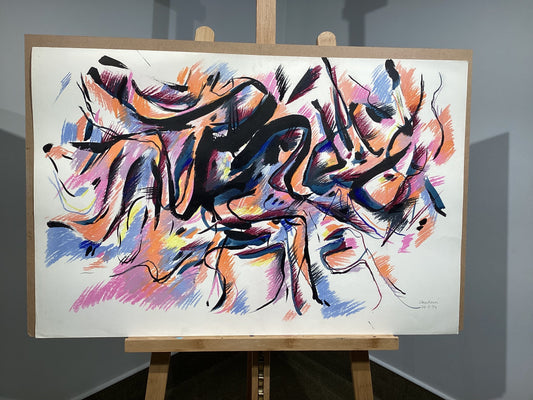 Abstract artwork on a white canvas with colorful brush strokes displayed on an easel.