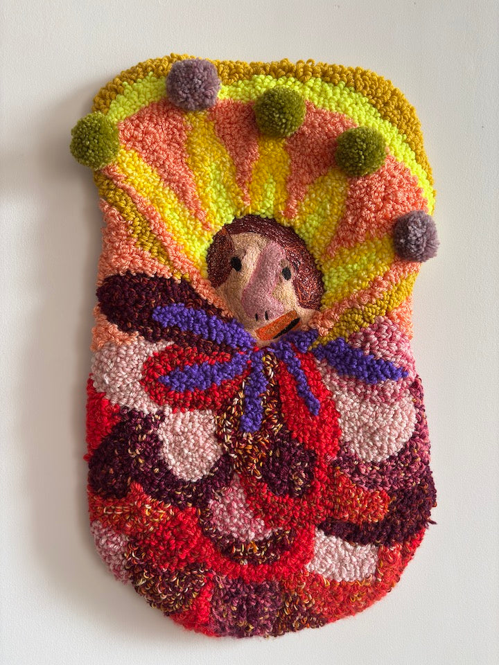 Colorful textured wall art with a small figure in the center on a white background